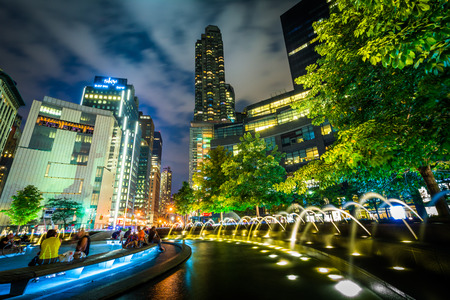Fountains and buildings at night at Columbus Circle, in Manhattan, New York.のeditorial素材