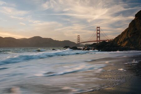 The Golden Gate Bridge at sunset, seen from Baker Beach, San Francisco, California.