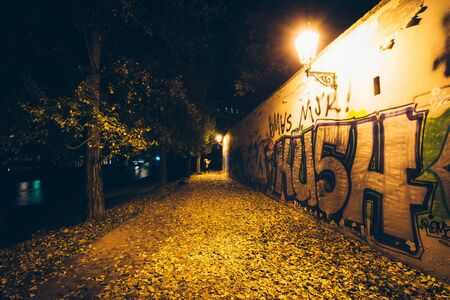 Graffiti on a wall at night, along the Vltava, in Prague, Czech Republic.のeditorial素材