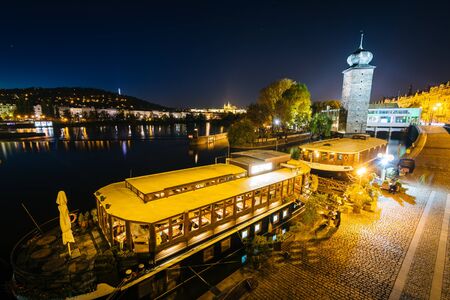 Boats and buildings along the Vltava at night, in Prague, Czech Republic.のeditorial素材