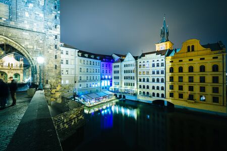 The Charles Bridge and buildings along the Vltava at night, in Prague, Czech Republic.のeditorial素材