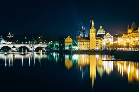 Charles Bridge and buildings along the Vltava at night, in Prague, Czech Republic.のeditorial素材