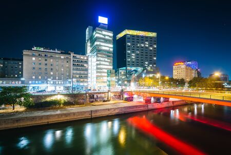 Modern buildings and bridge over the Danube Canal at night, in Vienna, Austria.のeditorial素材
