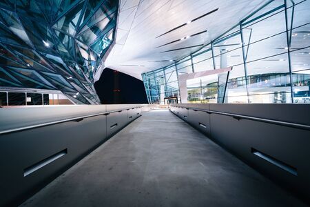 Walkway and exterior of BMW Welt at night, in Munich, Germany.のeditorial素材