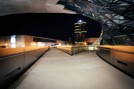 Walkway and exterior of BMW Welt at night, in Munich, Germany.のeditorial素材