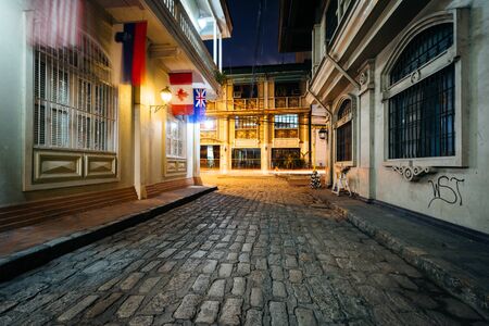 A cobblestone street at night, in Intramuros, Manila, The Philippines.の写真素材