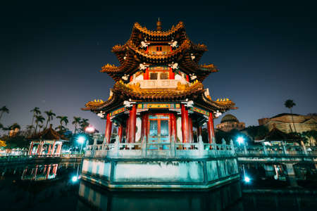 Traditional Chinese building and pond at night, at 2/28 Peace Park, in Taipei, Taiwan.のeditorial素材