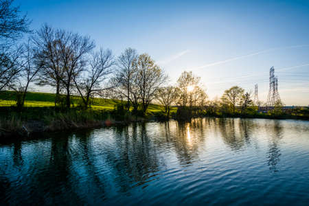 Lake at sunset, at Stansbury Park, in Dundalk, Maryland.の写真素材