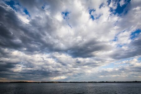 Dramatic sky over Lake Ontario, seen from the Harbourfront, in Toronto, Ontario.の写真素材