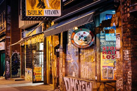 Businesses on Kensington Avenue, in Kensington Market, in Toronto, Ontario.のeditorial素材