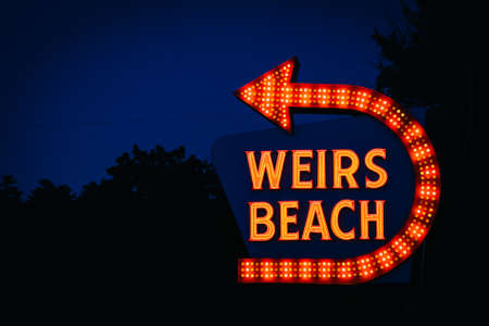 The Weirs Beach sign at night, in Laconia, New Hampshire.の写真素材