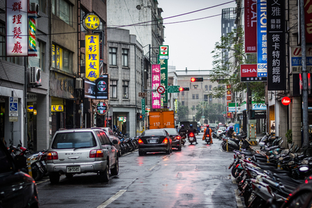 Street with colorful signs on a rainy day, in the Zhongzheng District, of Taipei, Taiwan.のeditorial素材