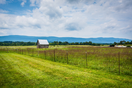 Fields and small shed, with mountains in the distance in Elkton, in the rural Shenandoah Valley of Virginia.の写真素材