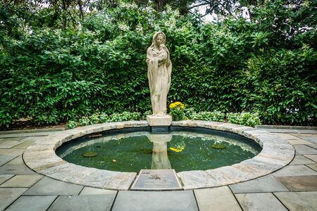 Statue and pool at the Mary's Garden, at the Basilica of the National Shrine of the Immaculate Conception, in Washington, DC.のeditorial素材