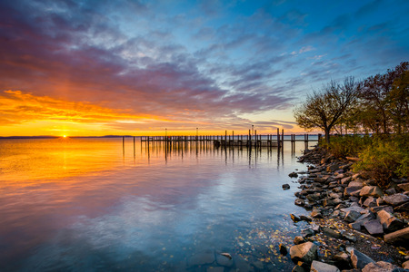 Sunrise over dock and the Chesapeake Bay, in Havre de Grace, Maryland.の写真素材