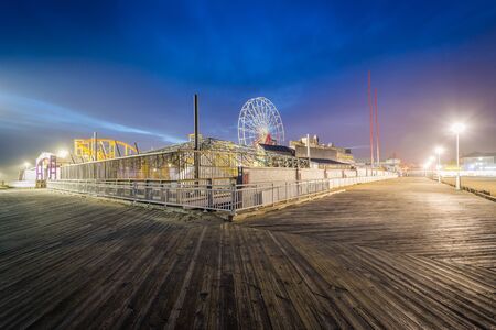 The boardwalk and rides at night, in Ocean City, Maryland.のeditorial素材