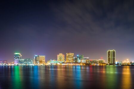 The skyline of Norfolk at night, seen from the waterfront in Portsmouth, Virginia.のeditorial素材