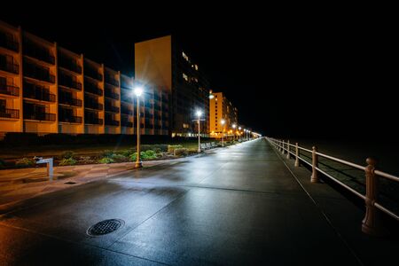 The boardwalk and highrise hotels at night in Virginia Beach, Virginia.の写真素材