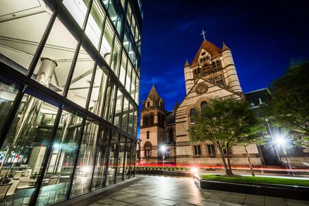 Trinity Church and a modern building at Copley at night, in Back Bay, Boston, Massachusetts.の写真素材