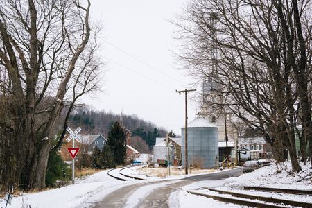 Snow covered railroad tracks and street, in Lineboro, Maryland.の写真素材