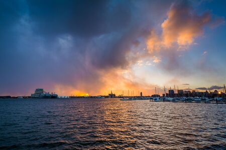 Dramatic sunset over the Patapsco River, at the Canton Waterfront, in Baltimore, Maryland.の写真素材