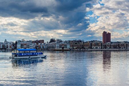A water taxi and waterfront residences at the Inner Harbor in Baltimore, Maryland.のeditorial素材