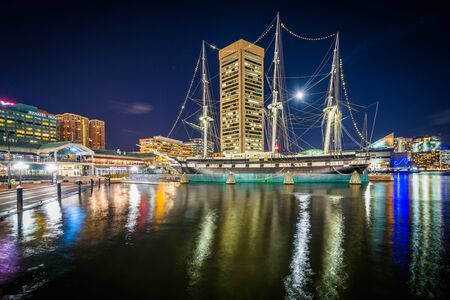 The USS Constellation and Inner Harbor skyline at night, in Baltimore, Maryland.のeditorial素材