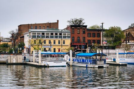 Boats docked on the waterfront in Fells Point, Baltimore, Maryland.のeditorial素材