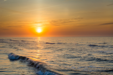 Sunrise over waves in the Atlantic Ocean in Ventnor City, New Jersey.の写真素材