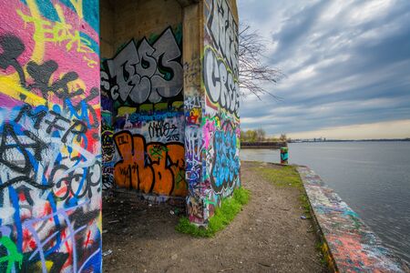 Graffiti and the Delaware River at Graffiit Pier in Philadelphia, Pennsylvania.のeditorial素材