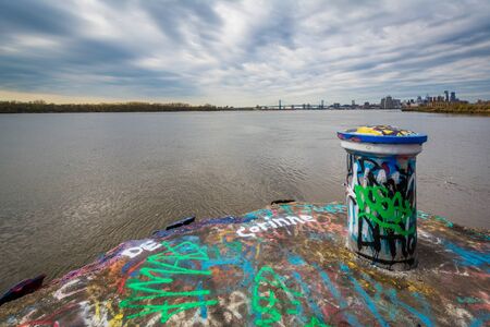 Graffiti and the Delaware River at Graffiit Pier in Philadelphia, Pennsylvania.の写真素材