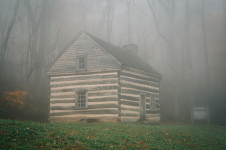 Cabin in fog and autumn color at Peaks of Otter, on the Blue Ridge Parkway in Virginia.の写真素材