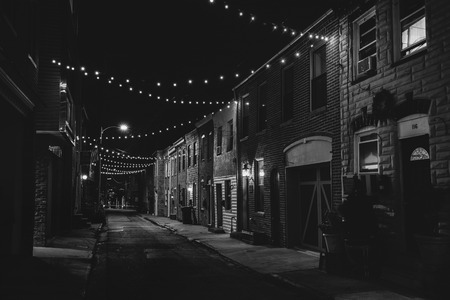 String lights over Chapel Street at night in Butchers Hill, Baltimore, Marylandのeditorial素材