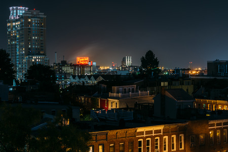 View of Federal Hill and the Domino Sugars Factory at night in Baltimore, Marylandのeditorial素材