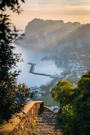 Staircase and view of Marina Grande at sunrise, in Capri, Italy