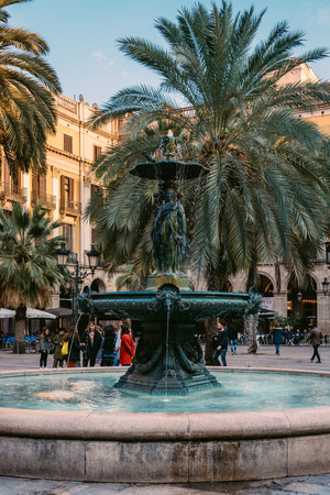 Fountain and palm trees at Placa Reial, in the Gothic Quarter, Barcelona, Spain