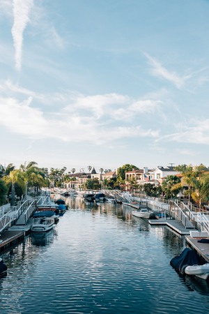 Boats and houses along a canal in Naples, Long Beach, Californiaの写真素材