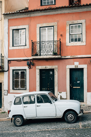 An old car on a cobblestone street in Lisbon, Portugalのeditorial素材