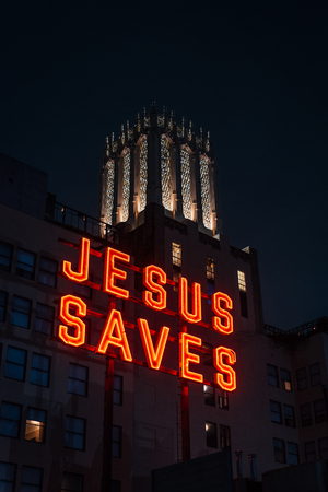 Jesus Saves sign at night, in downtown Los Angeles, Californiaのeditorial素材