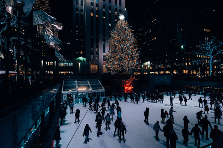 Christmas tree and ice skating rink at Rockefeller Center at night, in Midtown Manhattan, New York Cityのeditorial素材
