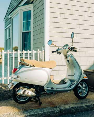 A scooter parked on the side of a street, Rockport, Massachusetts