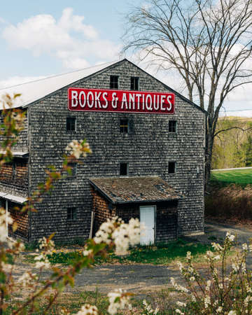 Old barn with Books & Antiques sign in Ellsworth, Maineのeditorial素材