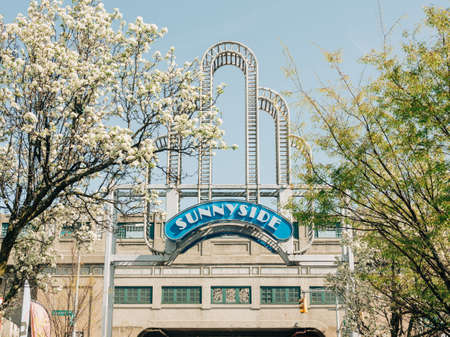 A building with a tower in the background, Sunnyside, Queens, New Yorkのeditorial素材