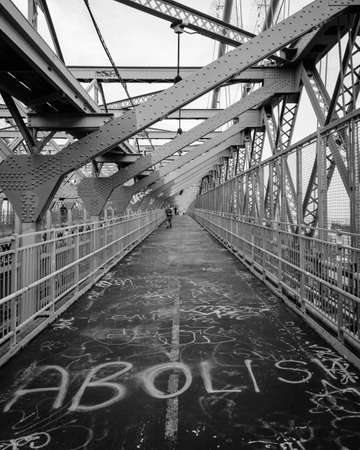 "Abolish" graffiti on the Williamsburg Bridge pedestrian walkway, in New York Cityのeditorial素材