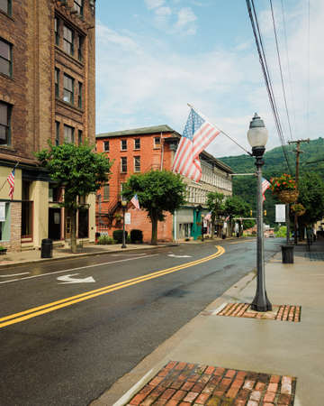 Street and American flags in downtown Hinton, West Virginiaの写真素材