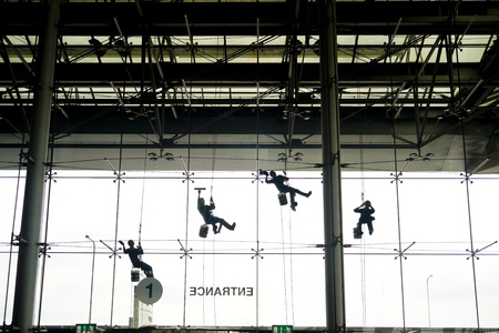 Window washers seen from inside the buildingの写真素材