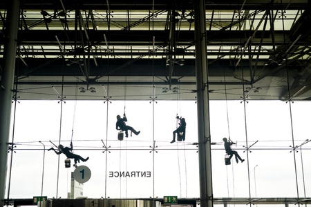 Window washers seen from inside the buildingの写真素材