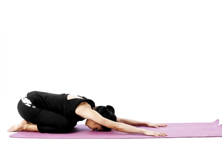 Asian female practising yoga in child poseの写真素材
