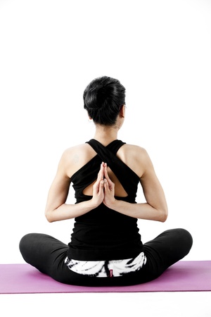 Asian female practising yoga in lotus position with hands clasped behindの写真素材
