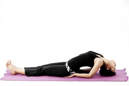 Asian female practising yoga in fish poseの写真素材